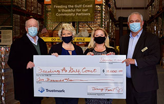 Trustmark presenting a check to a charity