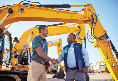 two men shaking hands on a job site