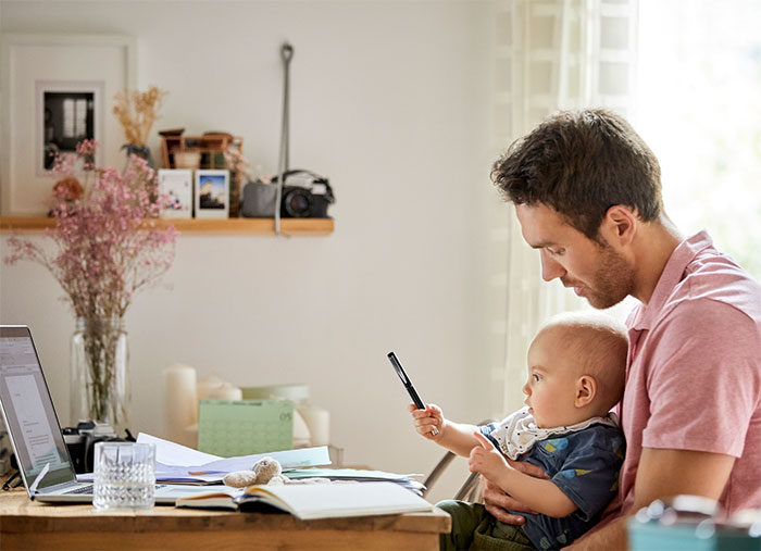 Man and infant son looking at smartphone.