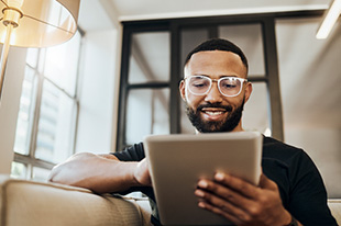 man looking at his tablet